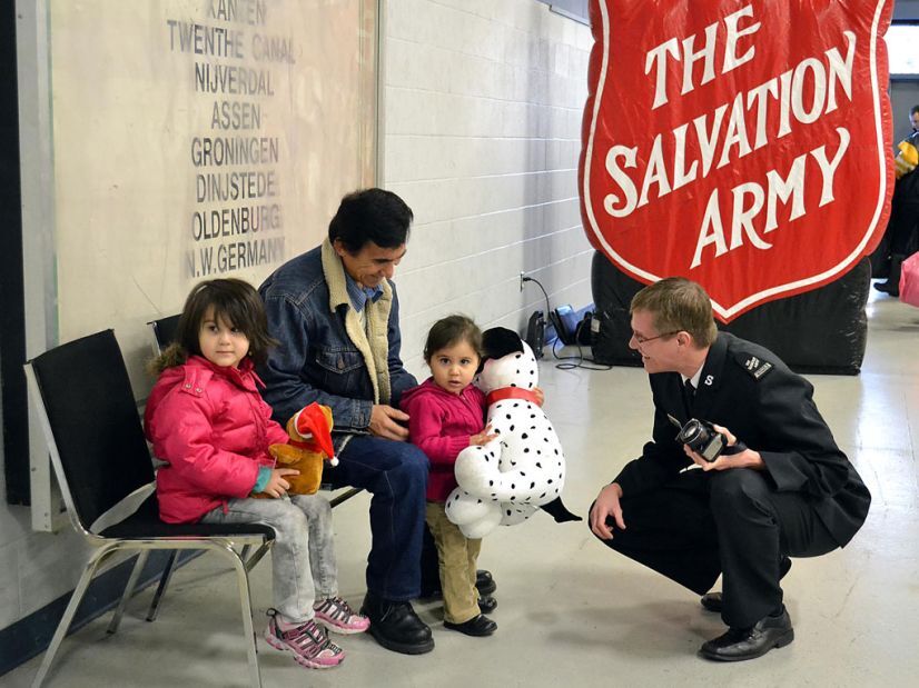 Salvation Army worker chatting with children